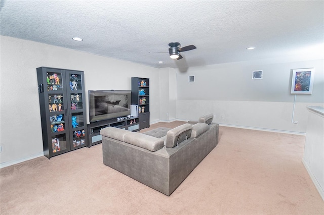 living room featuring carpet, ceiling fan, a textured ceiling, recessed lighting, and baseboards
