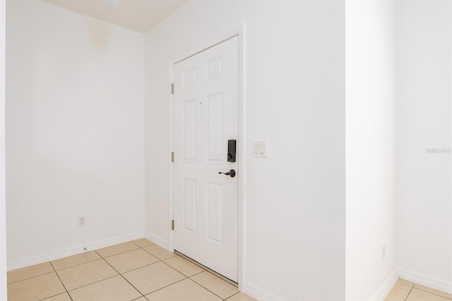 interior space featuring light tile patterned floors and baseboards