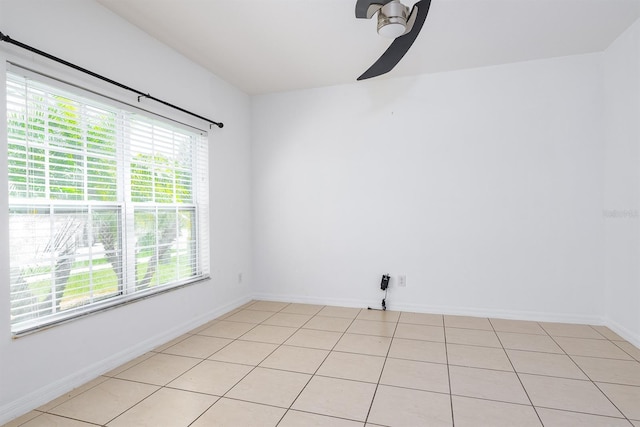 unfurnished room with baseboards and ceiling fan