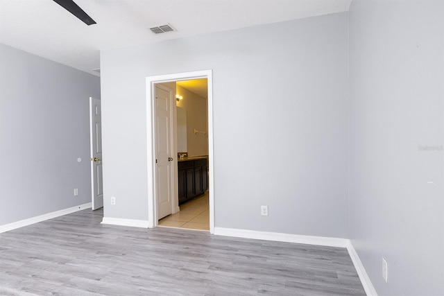 unfurnished room with visible vents, baseboards, and light wood-style flooring