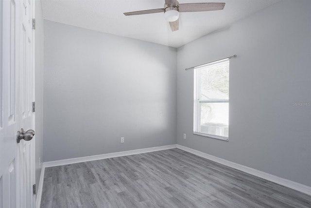 empty room with a ceiling fan, baseboards, and wood finished floors