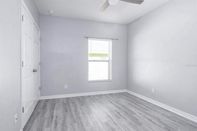 unfurnished bedroom with light wood-type flooring, baseboards, and ceiling fan