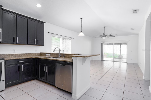 kitchen with a sink, dark cabinetry, a peninsula, light tile patterned floors, and dishwasher