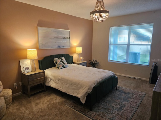 carpeted bedroom featuring an inviting chandelier and baseboards