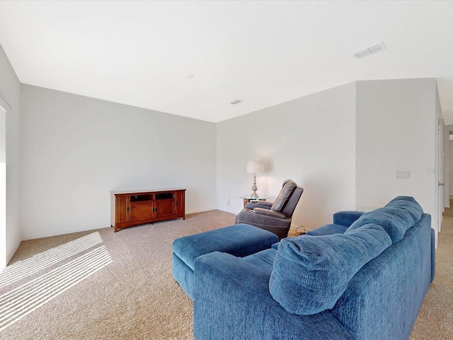 living area featuring light carpet and visible vents