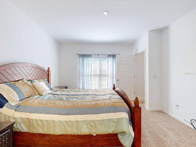 bedroom with carpet and baseboards