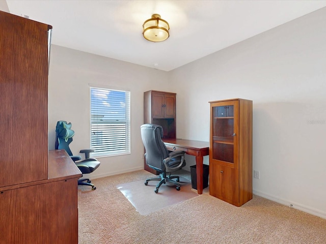 carpeted home office with baseboards