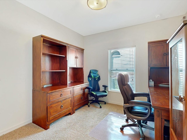 home office with light carpet and baseboards