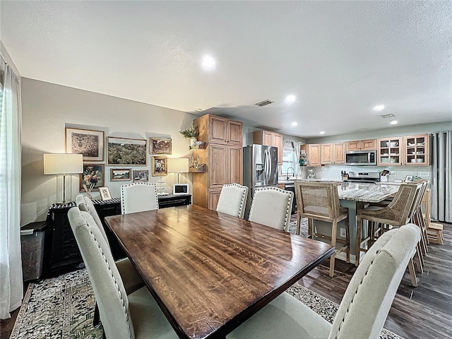 dining area featuring dark wood-style floors, a textured ceiling, visible vents, and recessed lighting