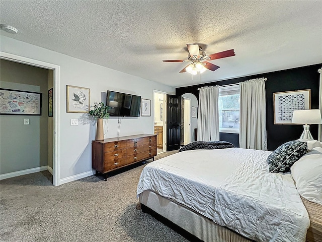 bedroom with arched walkways, a textured ceiling, a ceiling fan, baseboards, and carpet