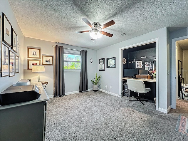 carpeted office with ceiling fan, a textured ceiling, and baseboards