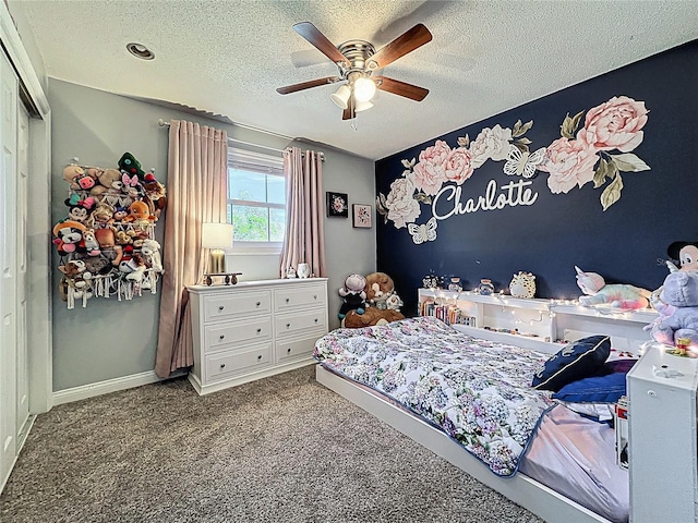 bedroom featuring a textured ceiling, carpet flooring, a ceiling fan, and baseboards