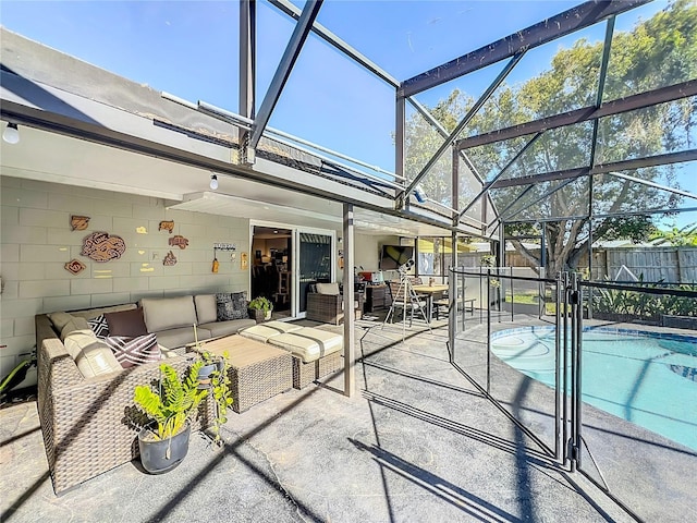 view of swimming pool featuring a patio, outdoor lounge area, fence, and a lanai