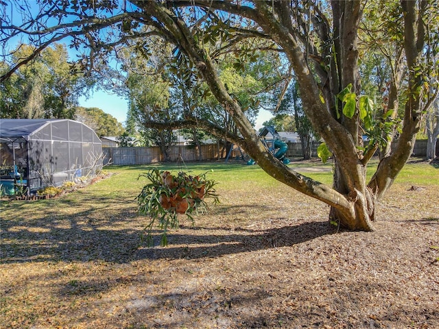 view of yard featuring a lanai and a fenced backyard