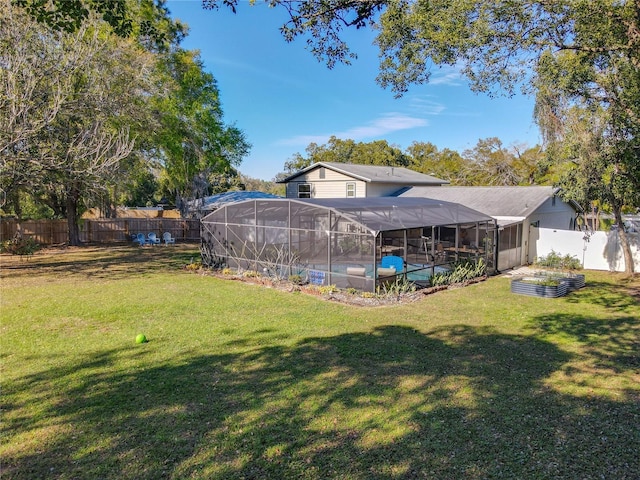 view of yard with a fenced in pool, glass enclosure, and a fenced backyard