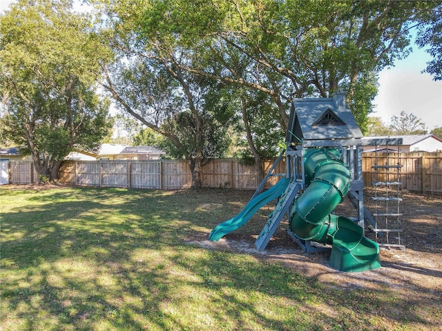 view of playground with a fenced backyard and a lawn