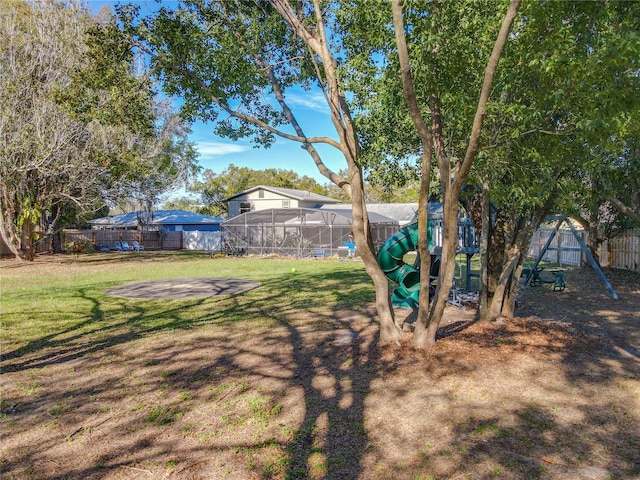 view of yard featuring a playground and fence