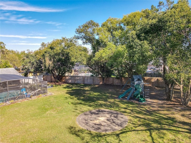 view of yard featuring a fenced backyard and a playground