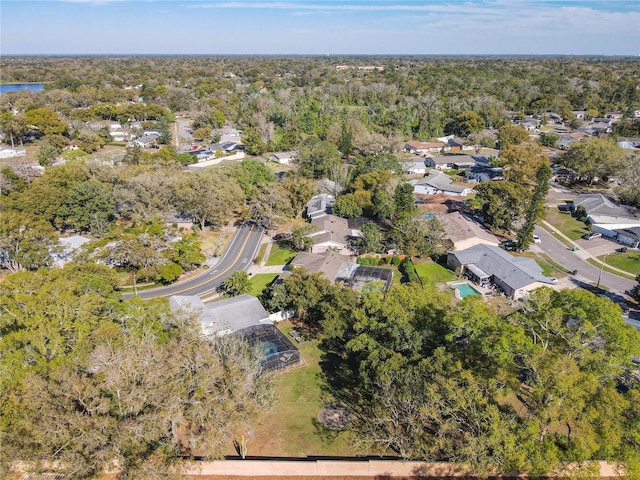 birds eye view of property featuring a forest view and a residential view