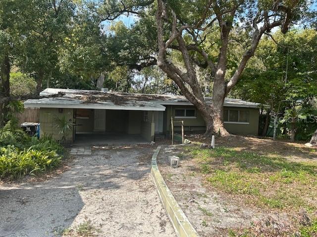 view of front of house featuring aphalt driveway and an attached carport