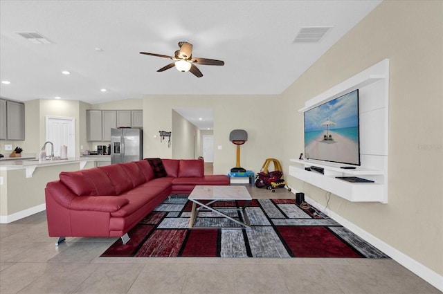 living room with light tile patterned floors, visible vents, and baseboards