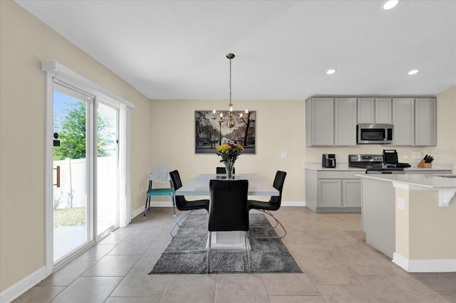 dining area with recessed lighting, baseboards, a notable chandelier, and light tile patterned floors