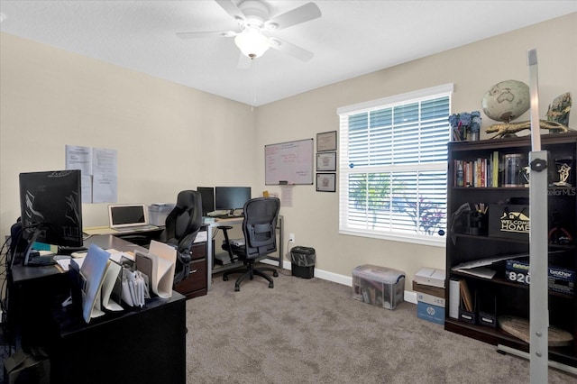 carpeted office with baseboards and ceiling fan