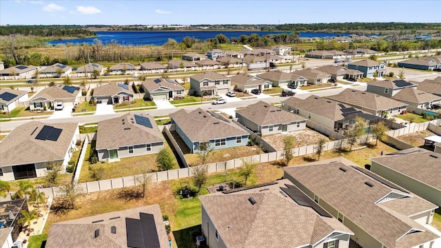 drone / aerial view featuring a residential view and a water view