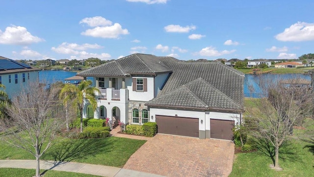 16629 Broadwater Ave, Winter Garden, FL 34787 - view of front of home featuring a balcony, an attached garage, stucco siding, a tile roof, and decorative driveway