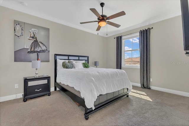 carpeted bedroom featuring a ceiling fan, crown molding, and baseboards