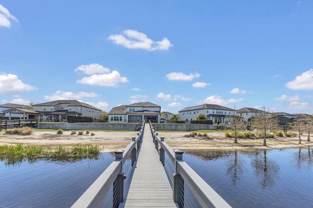 dock area with a residential view and a water view