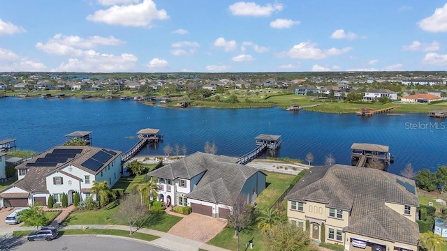 birds eye view of property with a residential view and a water view