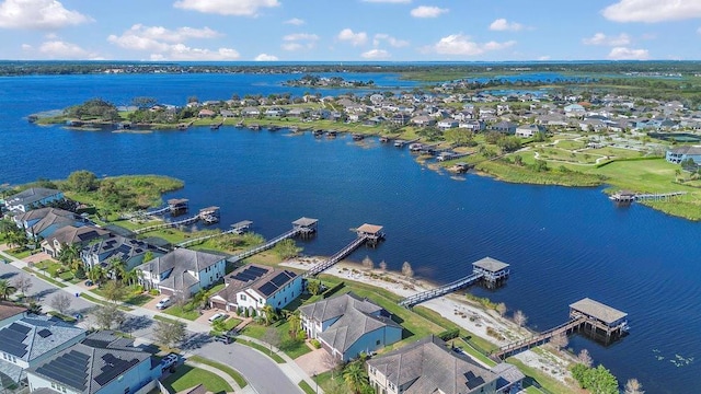 drone / aerial view with a residential view and a water view