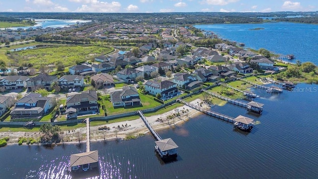 drone / aerial view with a water view and a residential view