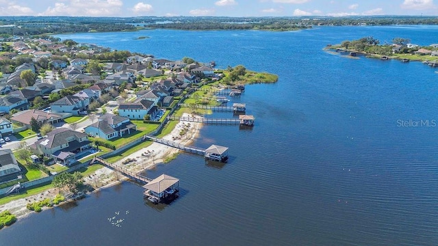 drone / aerial view featuring a residential view and a water view