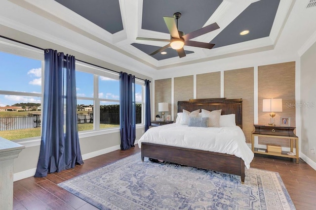 bedroom featuring baseboards, coffered ceiling, wood finished floors, and crown molding