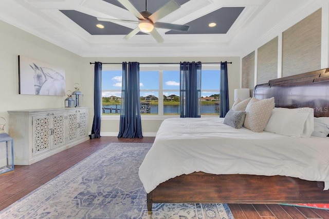 bedroom featuring baseboards, coffered ceiling, wood finished floors, and ornamental molding