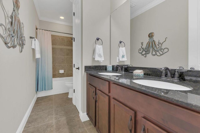 full bathroom with double vanity, ornamental molding, baseboards, and a sink