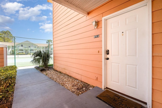 doorway to property with fence and a gate