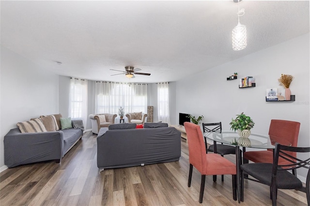 living room with ceiling fan and wood finished floors