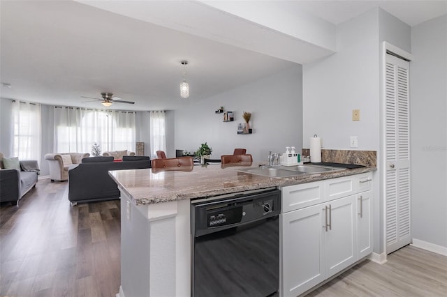 kitchen featuring light wood-style flooring, white cabinetry, a sink, dishwasher, and a peninsula