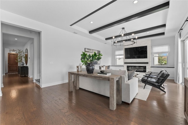 8025 Topsail Pl, Winter Garden, FL 34787 - living area with a chandelier, beamed ceiling, dark wood-type flooring, a large fireplace, and baseboards