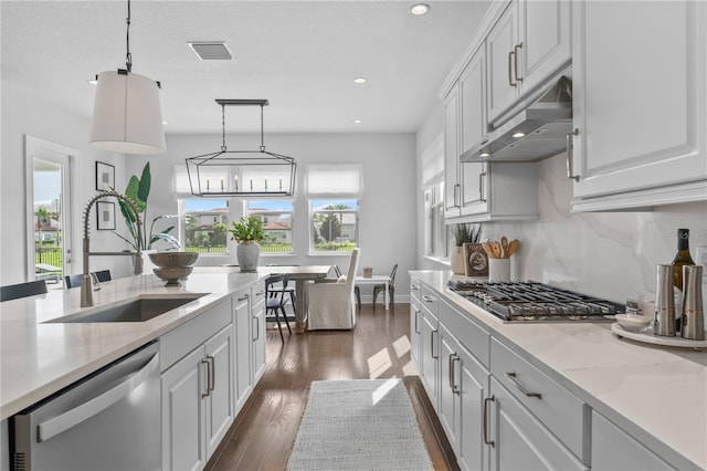 8025 Topsail Pl, Winter Garden, FL 34787 - kitchen with appliances with stainless steel finishes, a sink, under cabinet range hood, recessed lighting, and white cabinetry