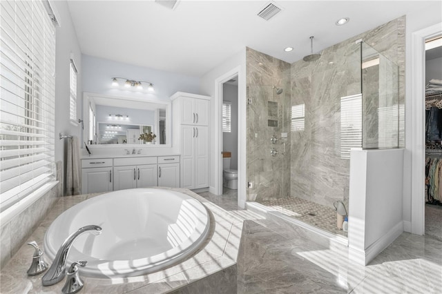 8025 Topsail Pl, Winter Garden, FL 34787 - bathroom featuring a stall shower, a bath, marble finish flooring, toilet, and a walk in closet