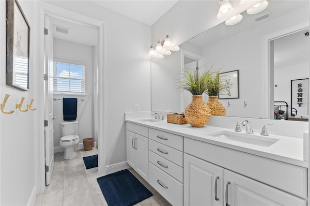8025 Topsail Pl, Winter Garden, FL 34787 - bathroom with double vanity, toilet, and baseboards