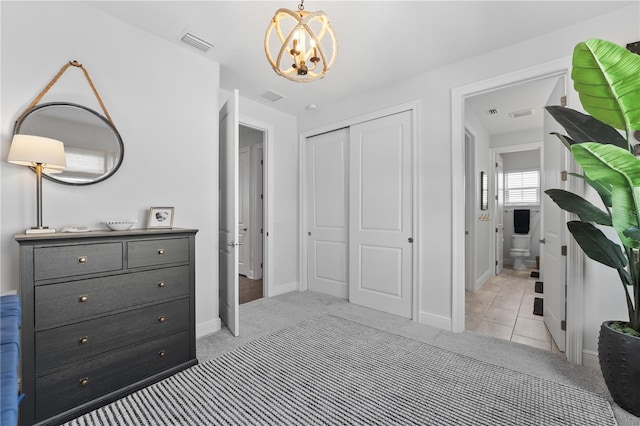 8025 Topsail Pl, Winter Garden, FL 34787 - bedroom with light colored carpet, a chandelier, baseboards, and a closet