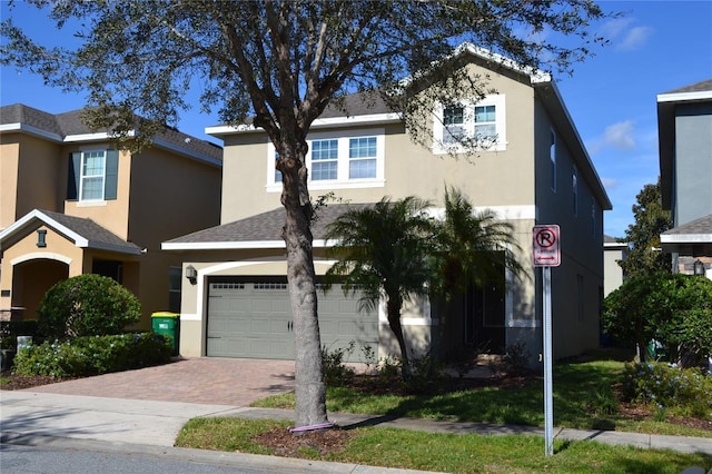 view of front of property with decorative driveway and stucco siding