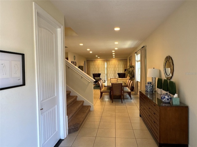 interior space featuring stairway, light tile patterned flooring, and recessed lighting