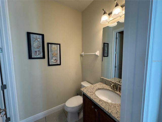 half bathroom featuring tile patterned flooring, baseboards, vanity, and toilet