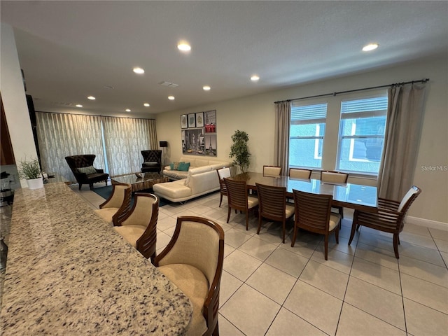 dining space featuring light tile patterned floors, baseboards, visible vents, and recessed lighting